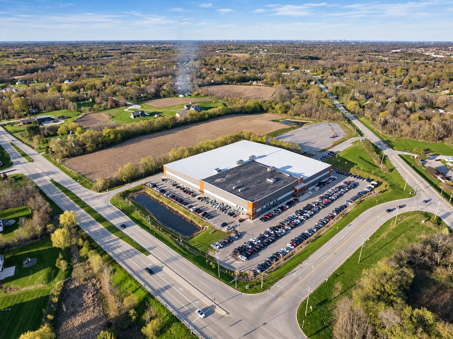 Aerial of a manufacturing facility and full parking lot in Southeastern Wisconsin