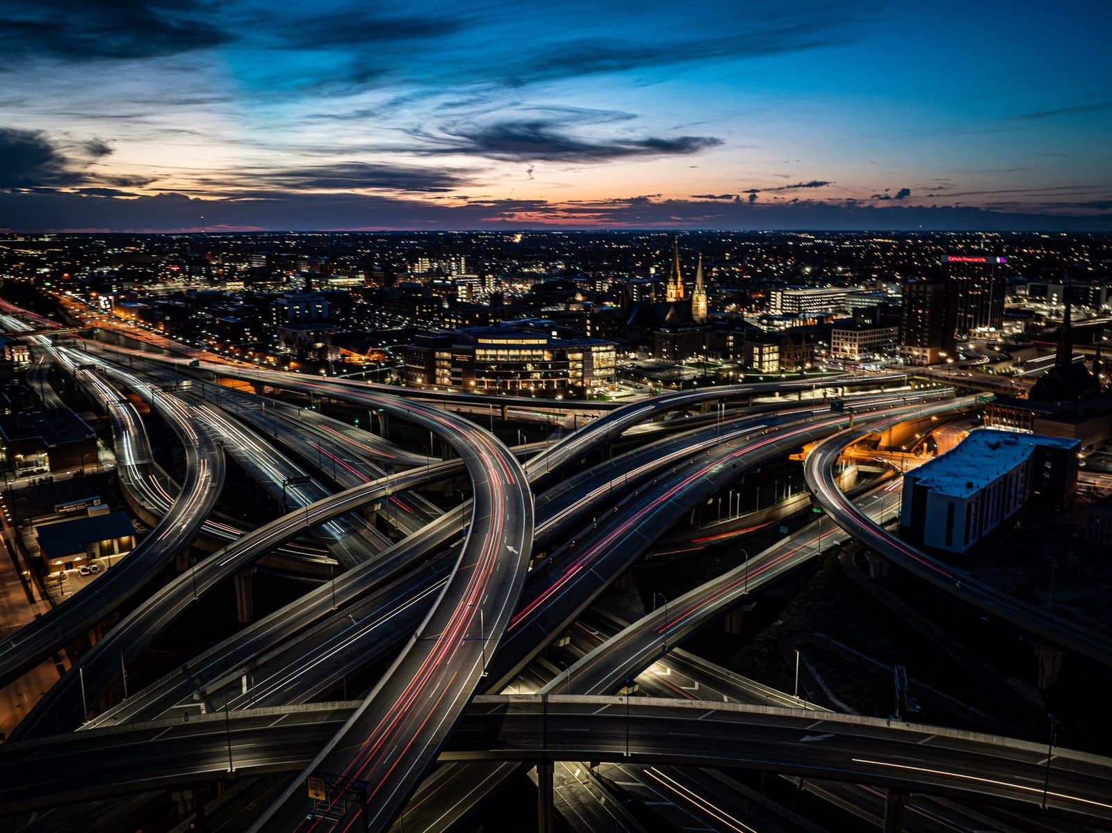 Aerial of the Marquette Interchange in Milwaukee at dusk with traffic light trails