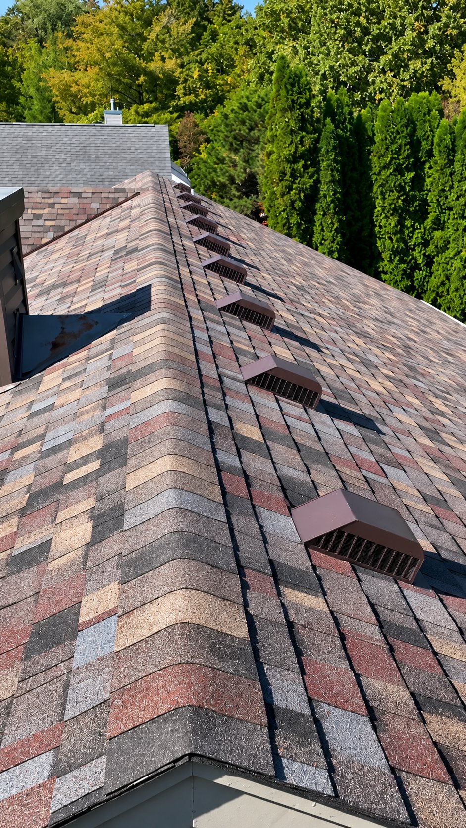 Close aerial of a residential roof ridge and vents, drone photo for a roofing contractor in Wisconsin