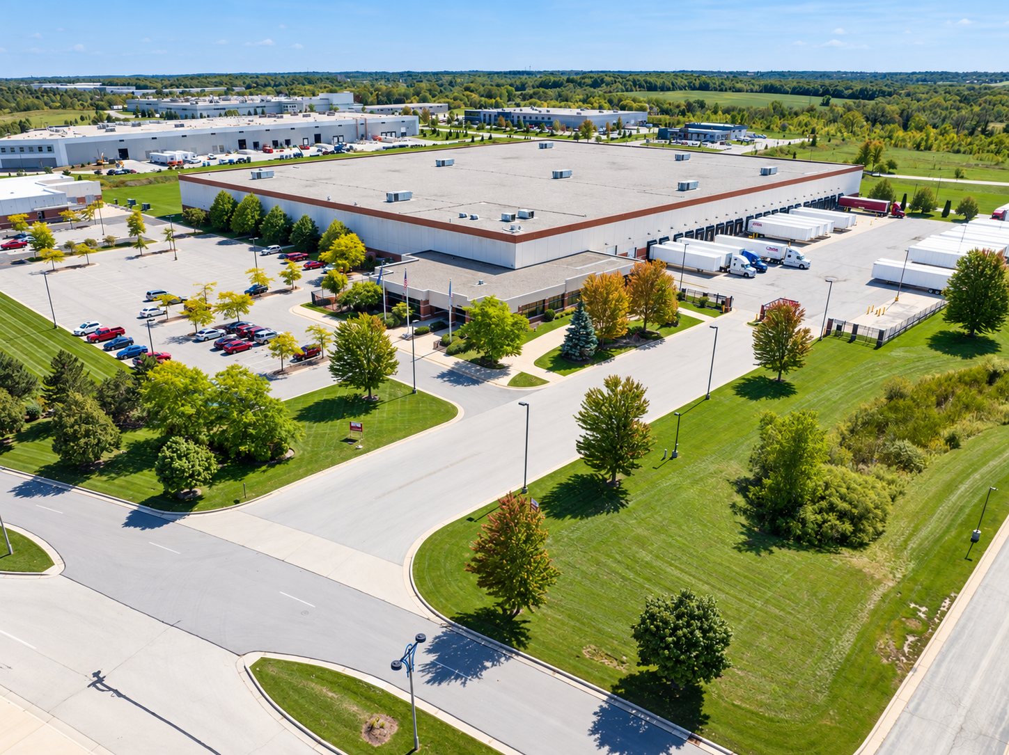 Aerial of a warehouse and distribution center with trucks at the docks