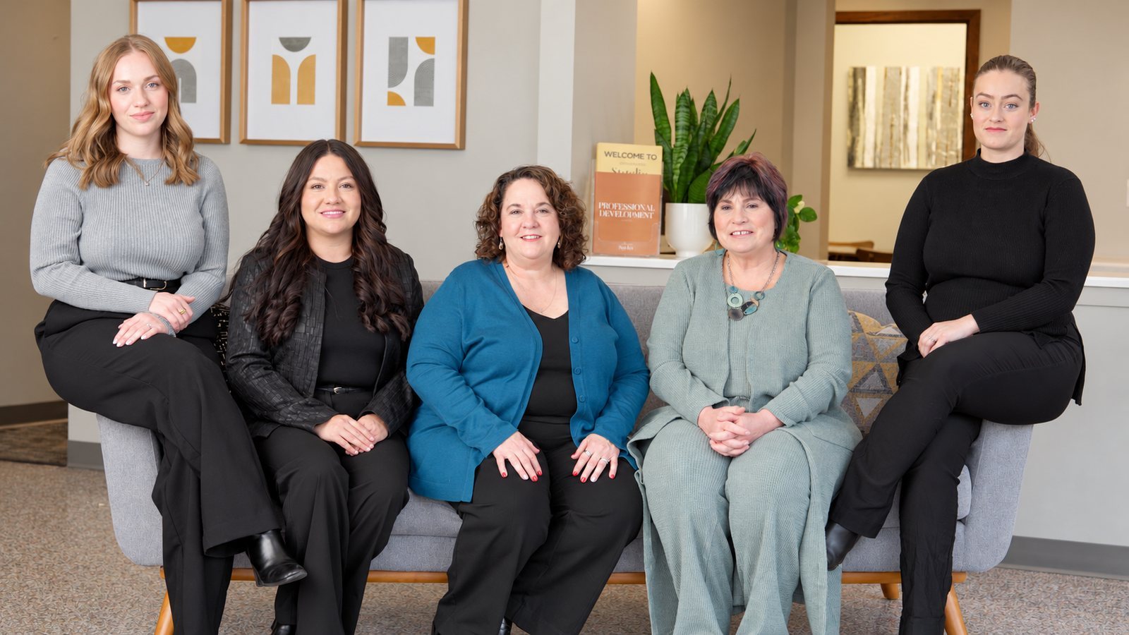 Office team seated together for a company video portrait