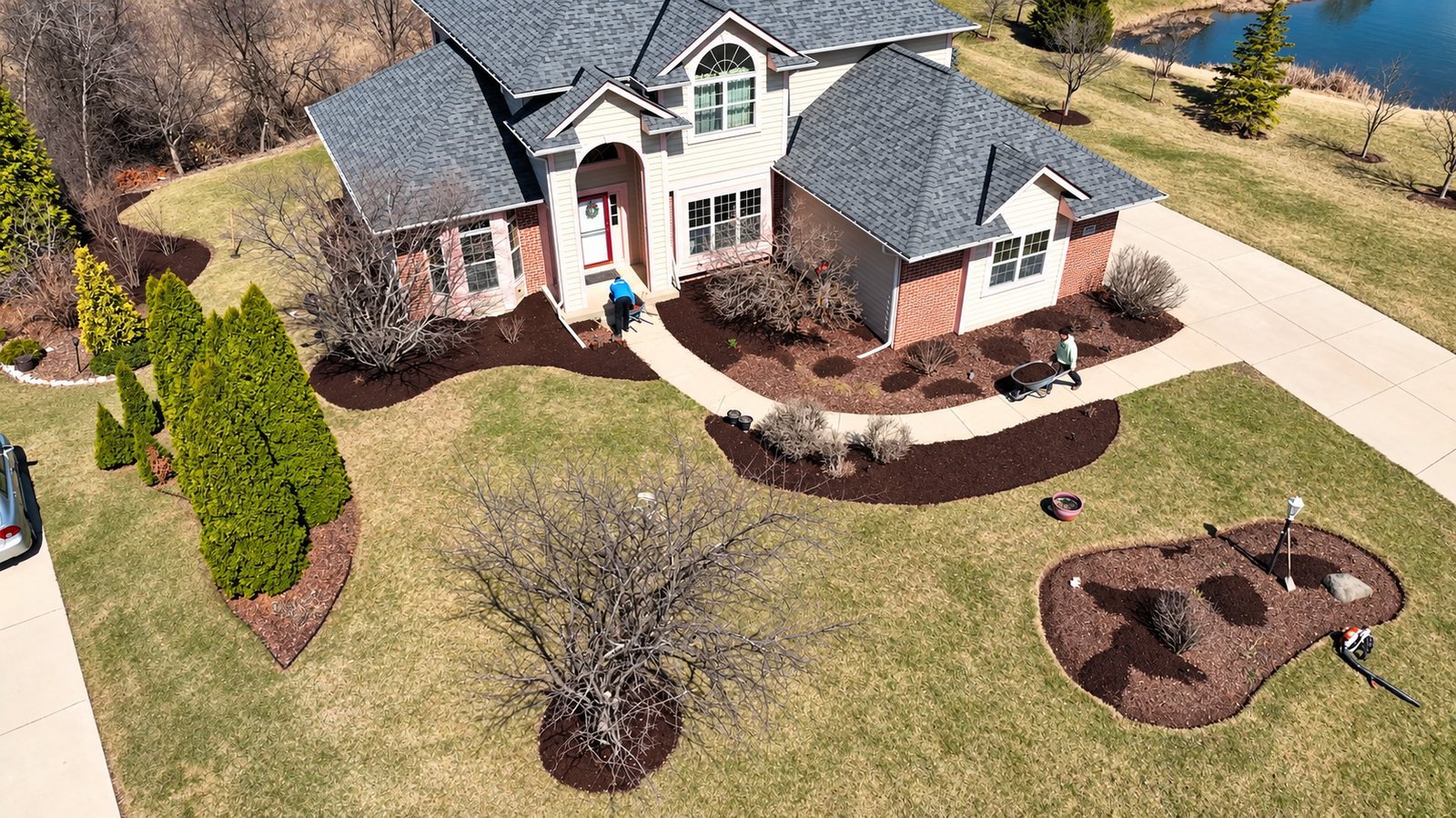 Aerial view of a landscaped home and crew at work